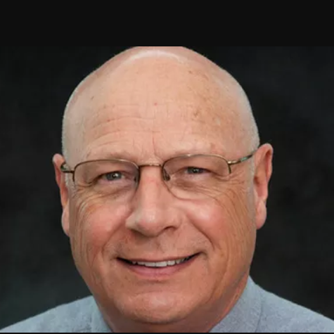 Certified Hand Therapist David Osteyee, P.T., CHT, smiling man in glasses and tie.